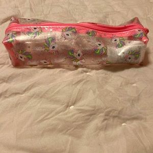 A pink, white, clear unicorn pouch. From: H&M. Name: Unicorn Pouch